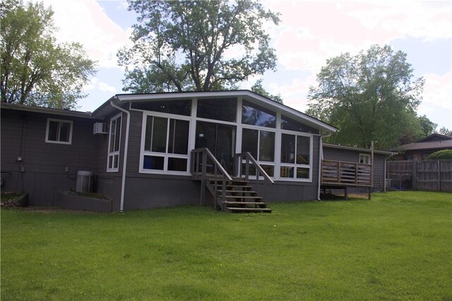 back of house with a sunroom, central AC unit, and an AC wall unit