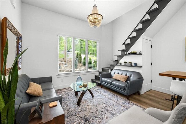 7 Thornbury Ln, Bella Vista, AR 72714 - living room featuring stairs, a chandelier, baseboards, and wood finished floors