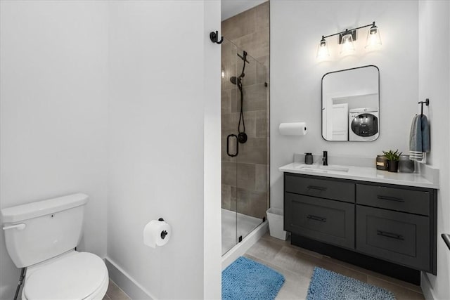 7 Thornbury Ln, Bella Vista, AR 72714 - bathroom featuring a stall shower, toilet, vanity, washer / clothes dryer, and baseboards