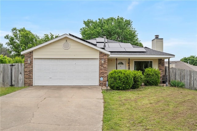 ranch-style home with brick siding, solar panels, concrete driveway, a chimney, and an attached garage