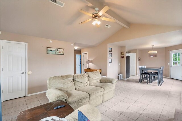 living room with light tile patterned flooring, a ceiling fan, and baseboards