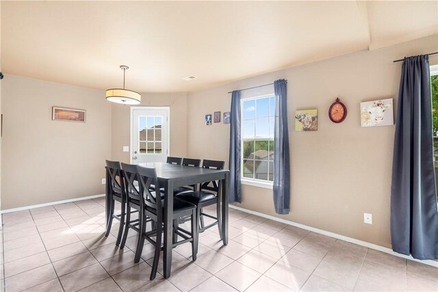 dining room with plenty of natural light, baseboards, and light tile patterned floors