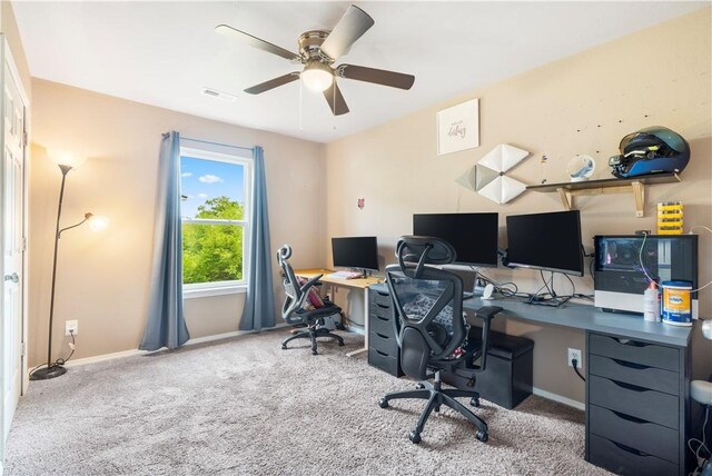 office space with a ceiling fan, baseboards, and carpet floors