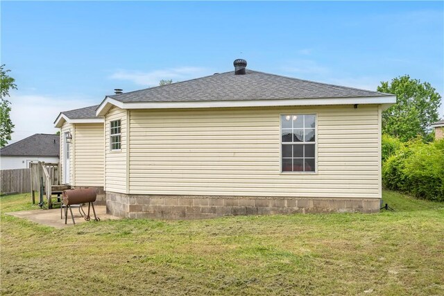 back of house featuring a shingled roof and a patio