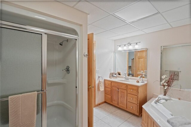 bathroom with a stall shower, tile patterned floors, vanity, a bath, and a drop ceiling