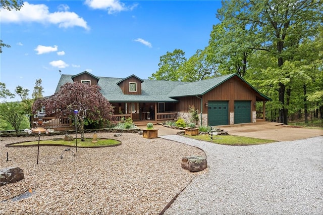 rustic home featuring a porch, concrete driveway, a garage, stone siding, and a shingled roof