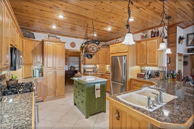 kitchen featuring appliances with stainless steel finishes, a sink, light tile patterned flooring, decorative backsplash, and pendant lighting