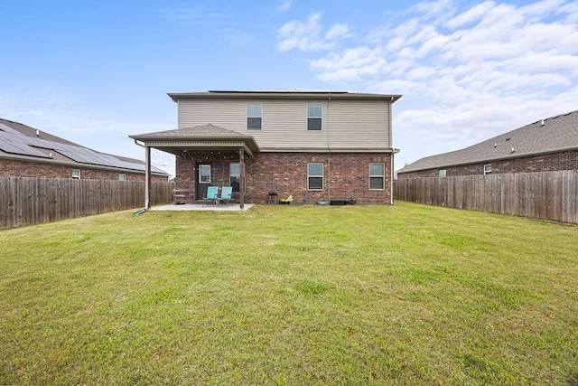 back of house featuring a patio and brick siding