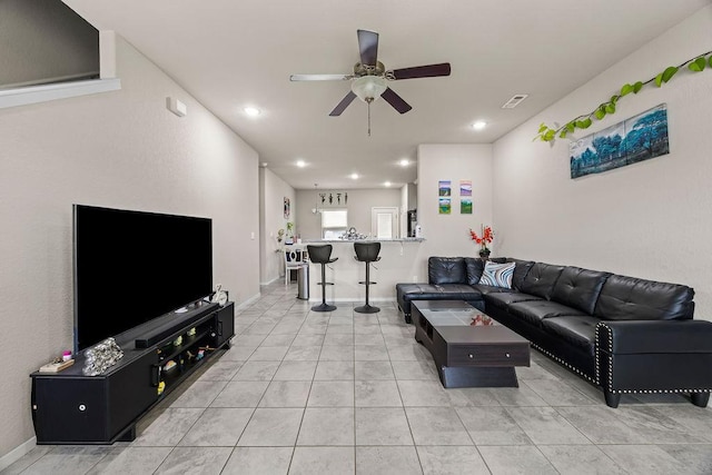 living room with ceiling fan, light tile patterned floors, recessed lighting, and baseboards