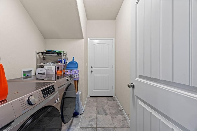 laundry area featuring washing machine and dryer and baseboards