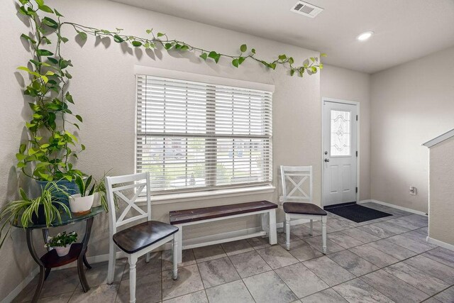 tiled entryway featuring baseboards