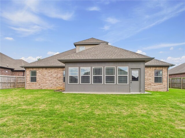 5708 S 60th Pl, Rogers, AR 72758 - back of property with a fenced backyard, a shingled roof, and brick siding