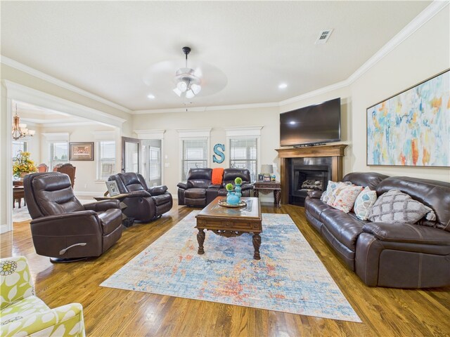 5708 S 60th Pl, Rogers, AR 72758 - living room with ceiling fan, ornamental molding, a fireplace, wood finished floors, and a chandelier