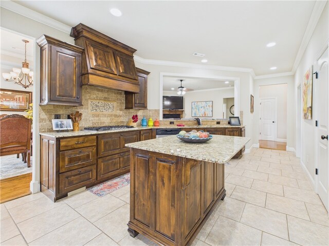 5708 S 60th Pl, Rogers, AR 72758 - kitchen with stainless steel appliances, light tile patterned floors, decorative backsplash, a center island, and light stone countertops