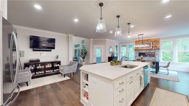 kitchen with a sink, stainless steel appliances, recessed lighting, open floor plan, and dark wood-style flooring