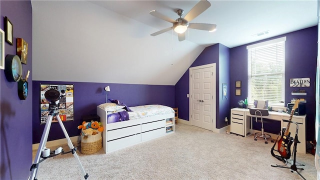 bedroom with an office area, vaulted ceiling, carpet, and a ceiling fan