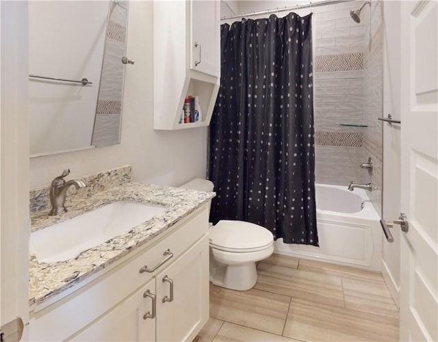 bathroom featuring shower / tub combo with curtain, toilet, and vanity