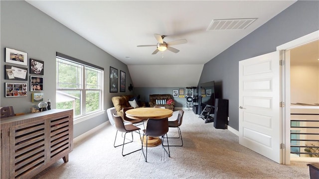 dining space featuring carpet floors, ceiling fan, lofted ceiling, and baseboards