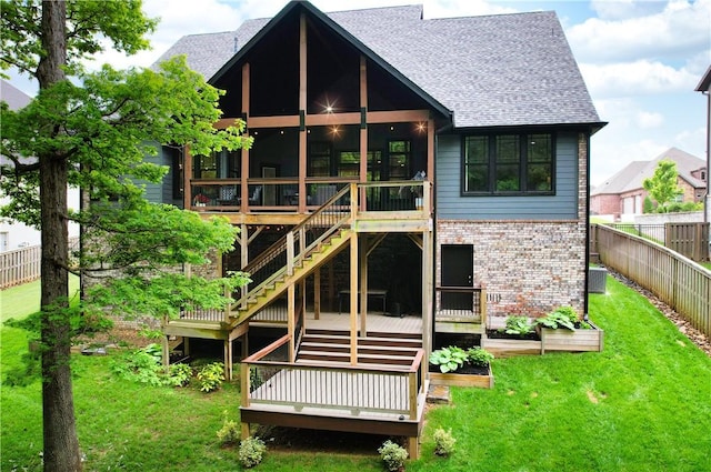 rear view of property with brick siding, a wooden deck, a shingled roof, and stairs