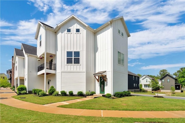 2630 N Gulley Grove Cir, Fayetteville, AR 72703 - modern farmhouse style home with board and batten siding, a front yard, and a residential view