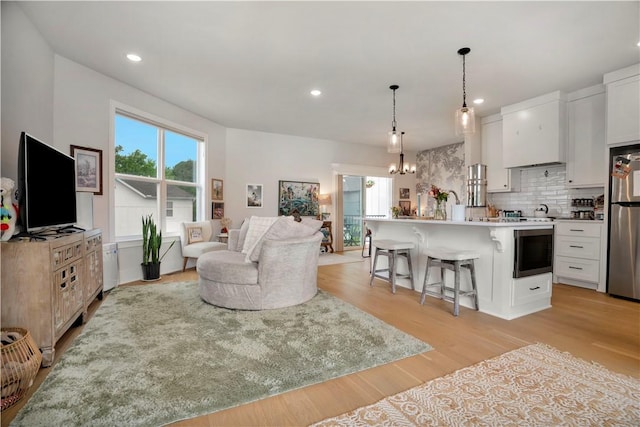2630 N Gulley Grove Cir, Fayetteville, AR 72703 - living area featuring light wood-style flooring, a chandelier, and recessed lighting