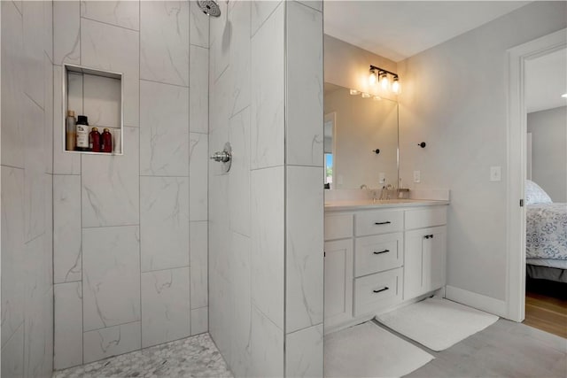 2630 N Gulley Grove Cir, Fayetteville, AR 72703 - ensuite bathroom featuring a tile shower, vanity, and wood finished floors