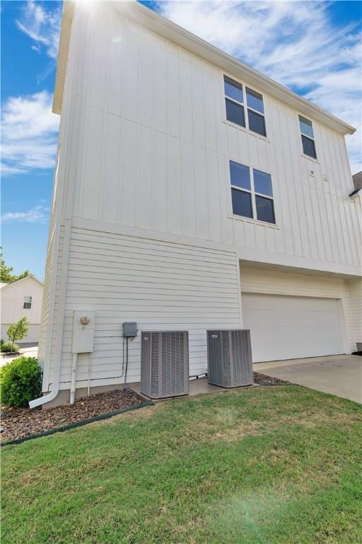 2630 N Gulley Grove Cir, Fayetteville, AR 72703 - view of home's exterior featuring central AC, board and batten siding, a garage, and driveway