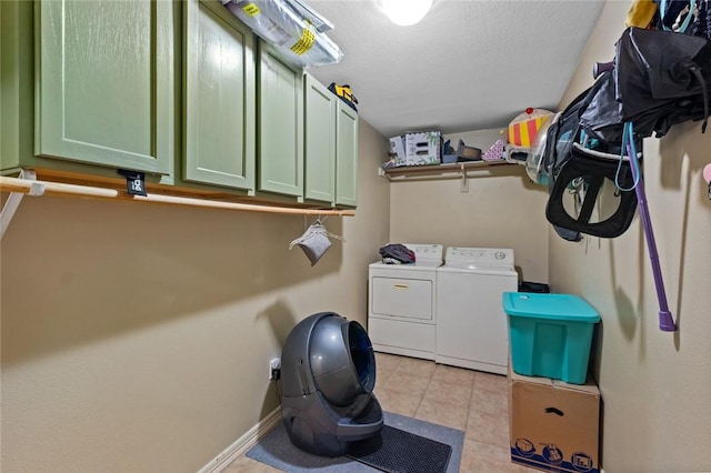 clothes washing area with cabinet space, separate washer and dryer, light tile patterned flooring, and baseboards