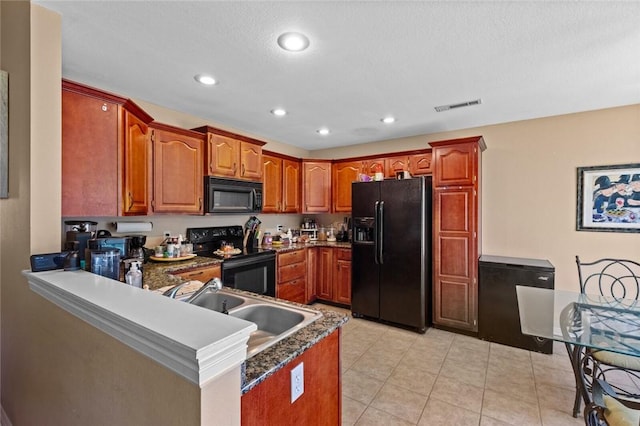 kitchen with black appliances, a peninsula, a sink, recessed lighting, and light tile patterned floors