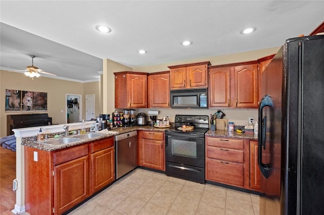 kitchen featuring black appliances, a sink, a peninsula, brown cabinetry, and open floor plan