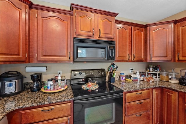 kitchen with black appliances, dark stone countertops, and brown cabinets