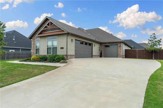 view of front of home with an attached garage, driveway, and stone siding