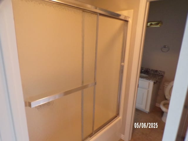 full bath with a shower with door, toilet, and tile patterned flooring