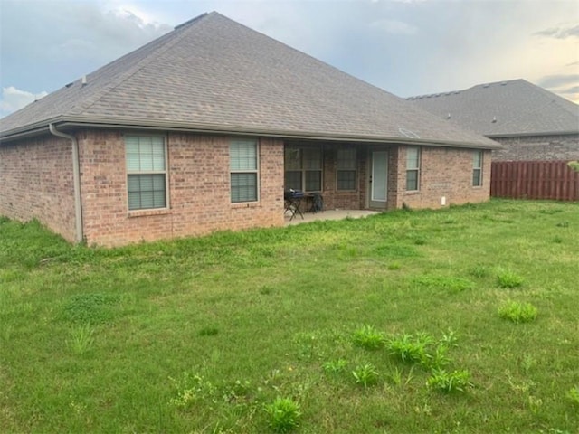 214 Hunt St, Pea Ridge, AR 72751 - rear view of property featuring brick siding, a patio, and roof with shingles