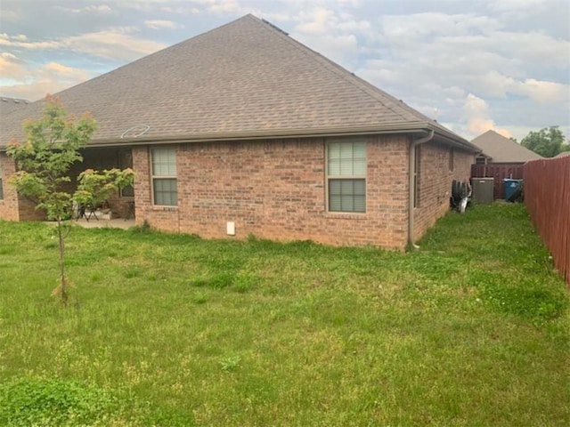 214 Hunt St, Pea Ridge, AR 72751 - view of home's exterior featuring a shingled roof and brick siding