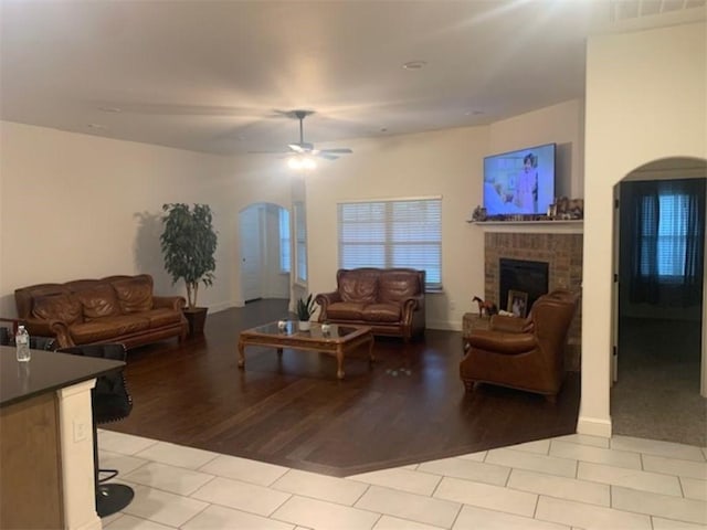 214 Hunt St, Pea Ridge, AR 72751 - living area with ceiling fan, arched walkways, a fireplace, and light tile patterned flooring