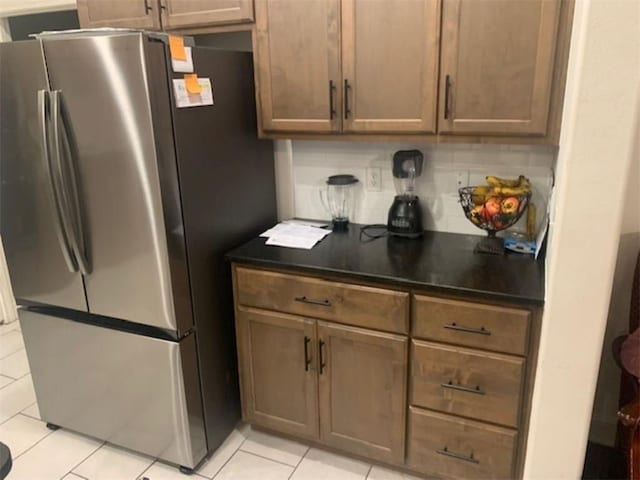 214 Hunt St, Pea Ridge, AR 72751 - kitchen with freestanding refrigerator, light tile patterned flooring, and dark countertops