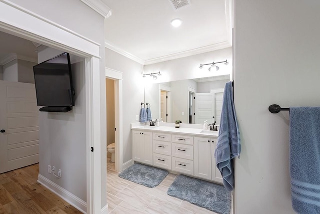 29 Salen Ln, Bella Vista, AR 72715 - bathroom featuring crown molding, double vanity, toilet, and baseboards