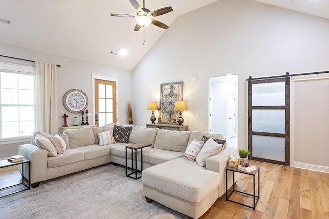 29 Salen Ln, Bella Vista, AR 72715 - living room featuring a barn door, high vaulted ceiling, a ceiling fan, and light wood-type flooring