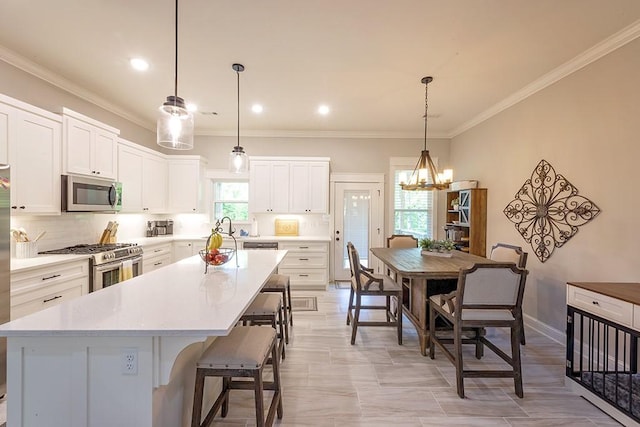 29 Salen Ln, Bella Vista, AR 72715 - kitchen featuring stainless steel appliances, a center island, white cabinets, light countertops, and crown molding