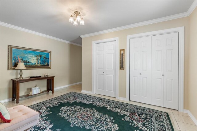 interior space with light tile patterned floors, crown molding, baseboards, and a chandelier