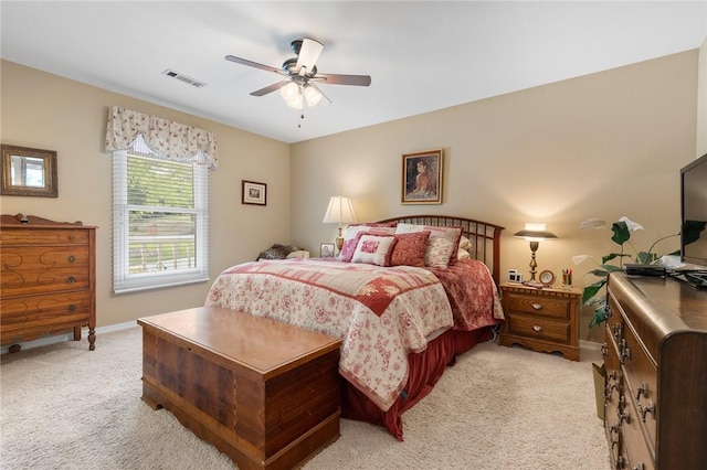 bedroom with light colored carpet, baseboards, and ceiling fan