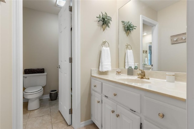 bathroom featuring toilet, vanity, and tile patterned flooring