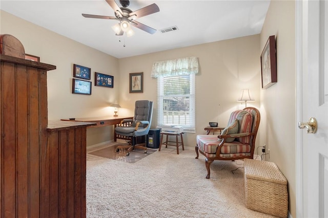 home office featuring carpet floors, a ceiling fan, and baseboards