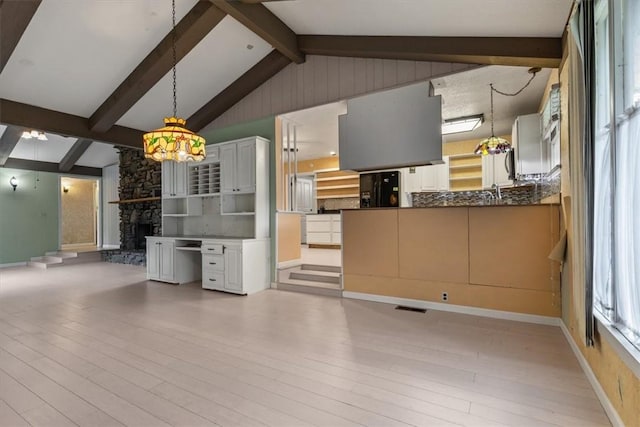 kitchen featuring wood finished floors, black fridge with ice dispenser, a fireplace, and pendant lighting