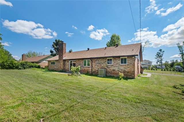 1104 S 12th St, Rogers, AR 72756 - rear view of property featuring brick siding, a yard, central air condition unit, and a chimney