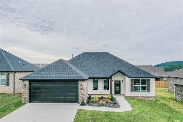 181 Magazine, Prairie Grove, AR 72753 - view of front facade featuring a garage, roof with shingles, a front yard, driveway, and brick siding