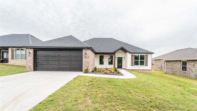 181 Magazine, Prairie Grove, AR 72753 - view of front of home with an attached garage, concrete driveway, a front lawn, and brick siding