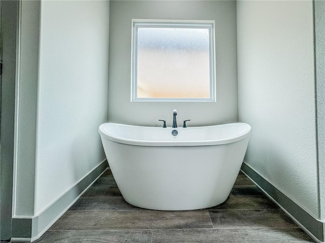 181 Magazine, Prairie Grove, AR 72753 - bathroom with a soaking tub, wood finished floors, and baseboards