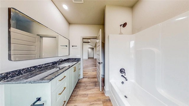 181 Magazine, Prairie Grove, AR 72753 - bathroom with vanity, bathing tub / shower combination, and wood finished floors